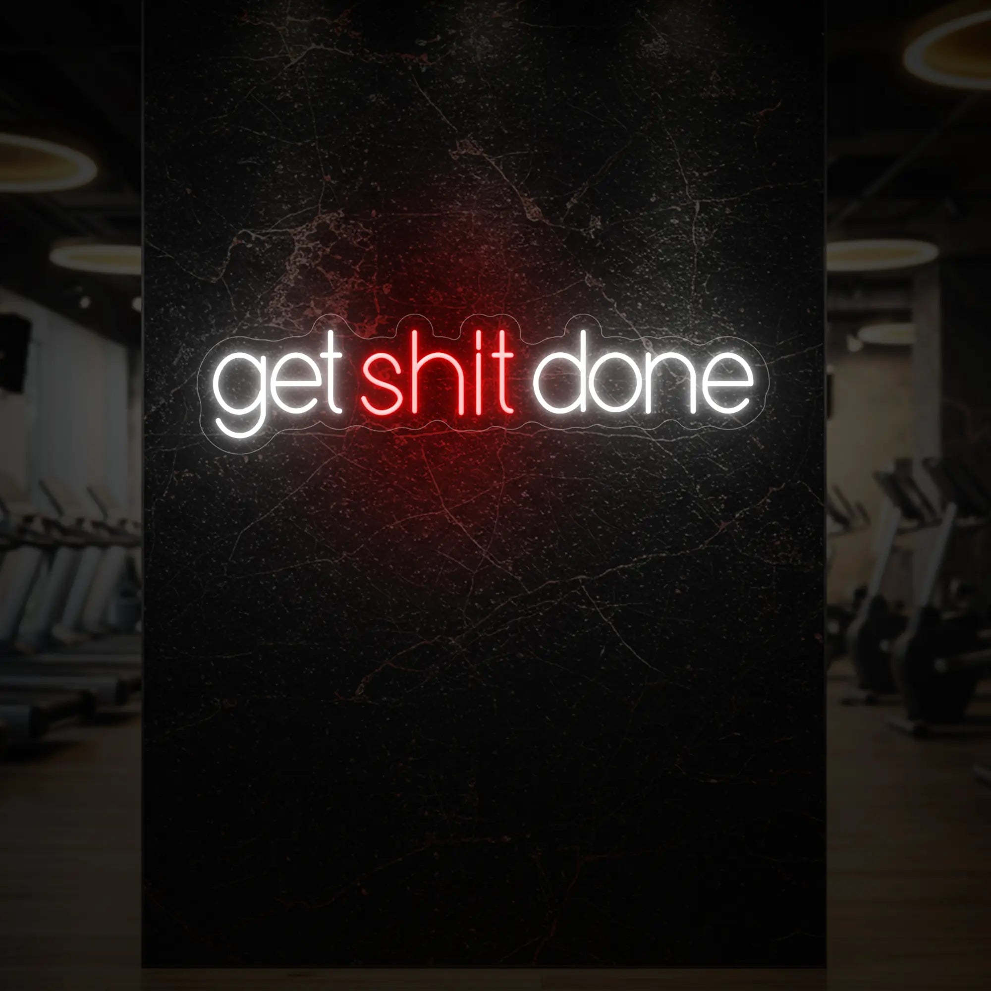 'Get Shit Done' neon sign glowing in red against a styled interior wall.