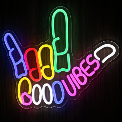 Good Vibes hand LED neon sign with green, blue, red, yellow, pink and cool white illumination on clear acrylic backing.