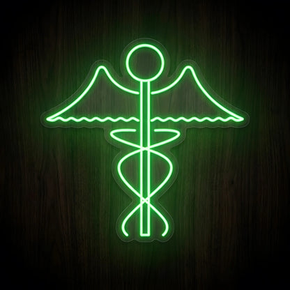 Green Caduceus Medical Symbol LED Neon Sign featuring a glowing green winged medical staff with intertwined serpentine lines on clear cut-to-shape acrylic against a dark wooden wall.