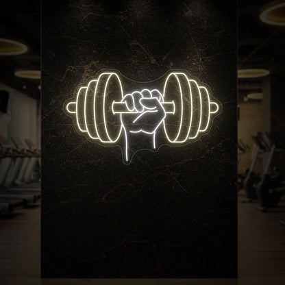  'Hand Holding a Weight' neon sign glowing in warm white against a styled interior wall.