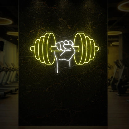 'Hand Holding a Weight' neon sign glowing in lemon yellow against a styled interior wall.