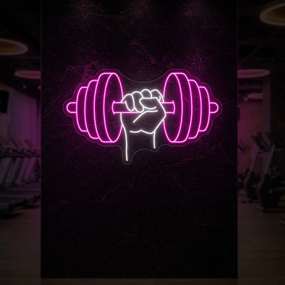 'Hand Holding a Weight' neon sign glowing in light pink against a styled interior wall.
