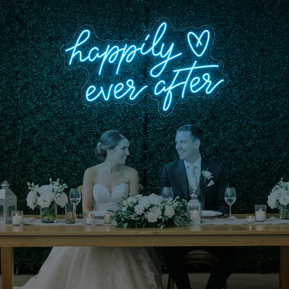 Photo of the 'Happily Ever After' neon sign glowing in ice blue against a styled interior wall.