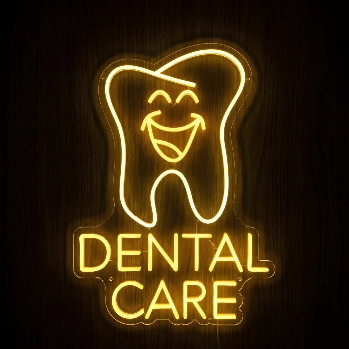 Happy Tooth Dental Care LED neon sign featuring a cheerful smiling tooth above Dental Care lettering in glowing golden-yellow neon on clear acrylic backing against a dark wooden wall.
