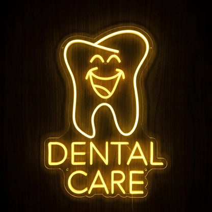 Happy Tooth Dental Care LED neon sign featuring a cheerful smiling tooth above Dental Care lettering in glowing golden-yellow neon on clear acrylic backing against a dark wooden wall.