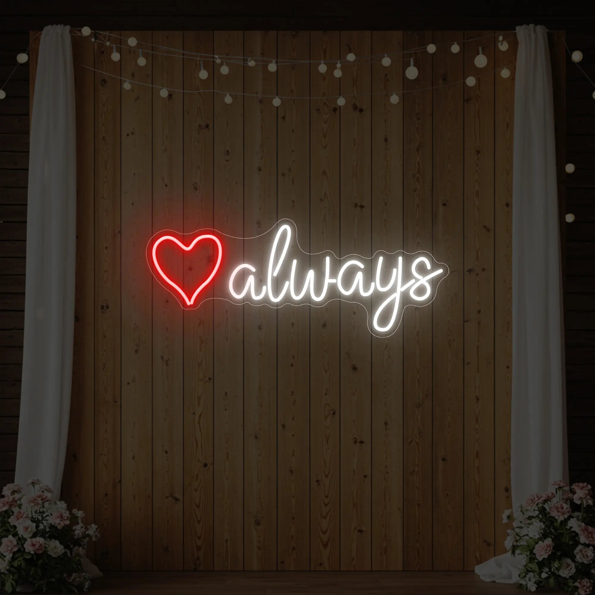 Photo of the 'Heart Always' neon sign glowing in red and cool white against a styled interior wall.