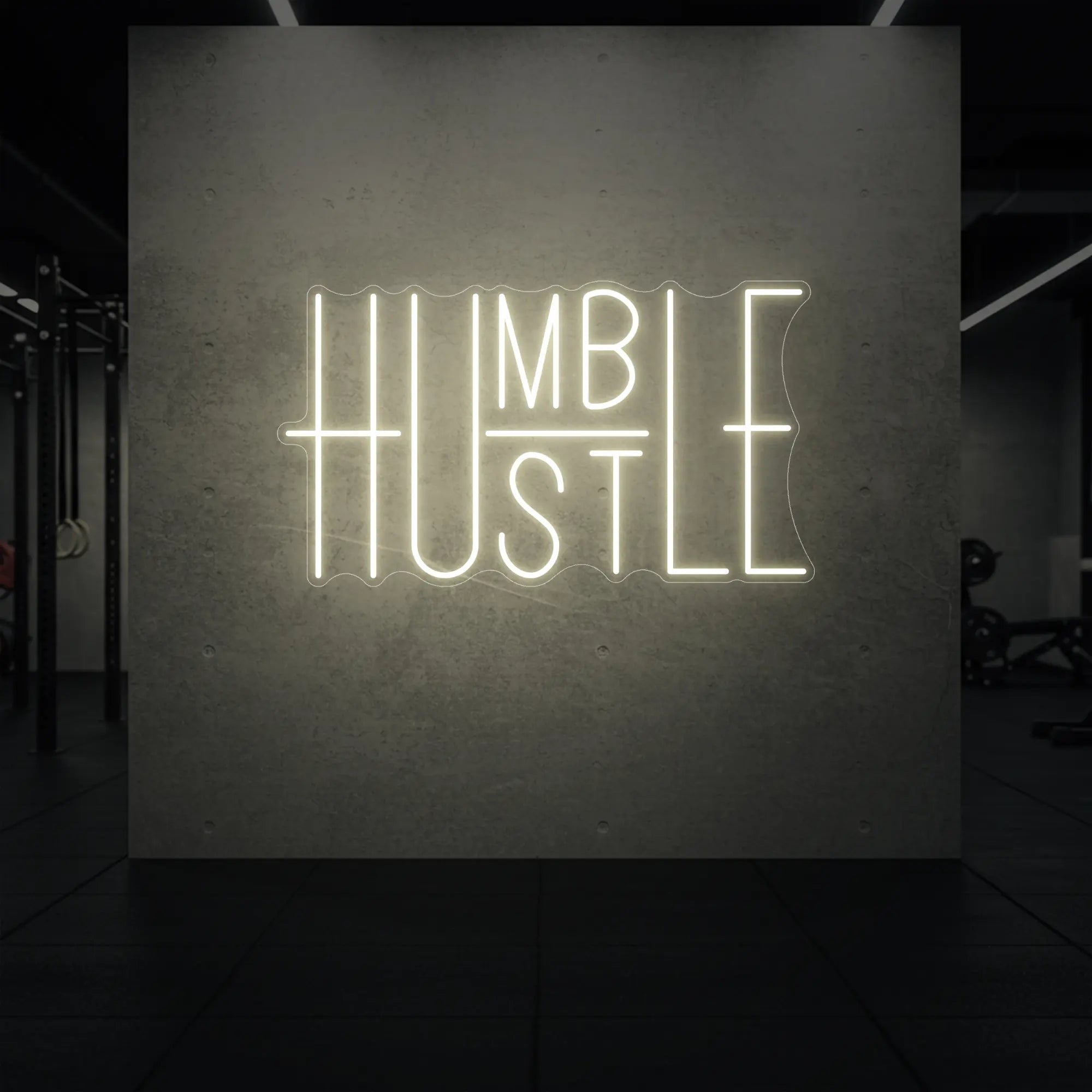 'Humble Hustle' neon sign glowing in warm white against a styled interior wall.