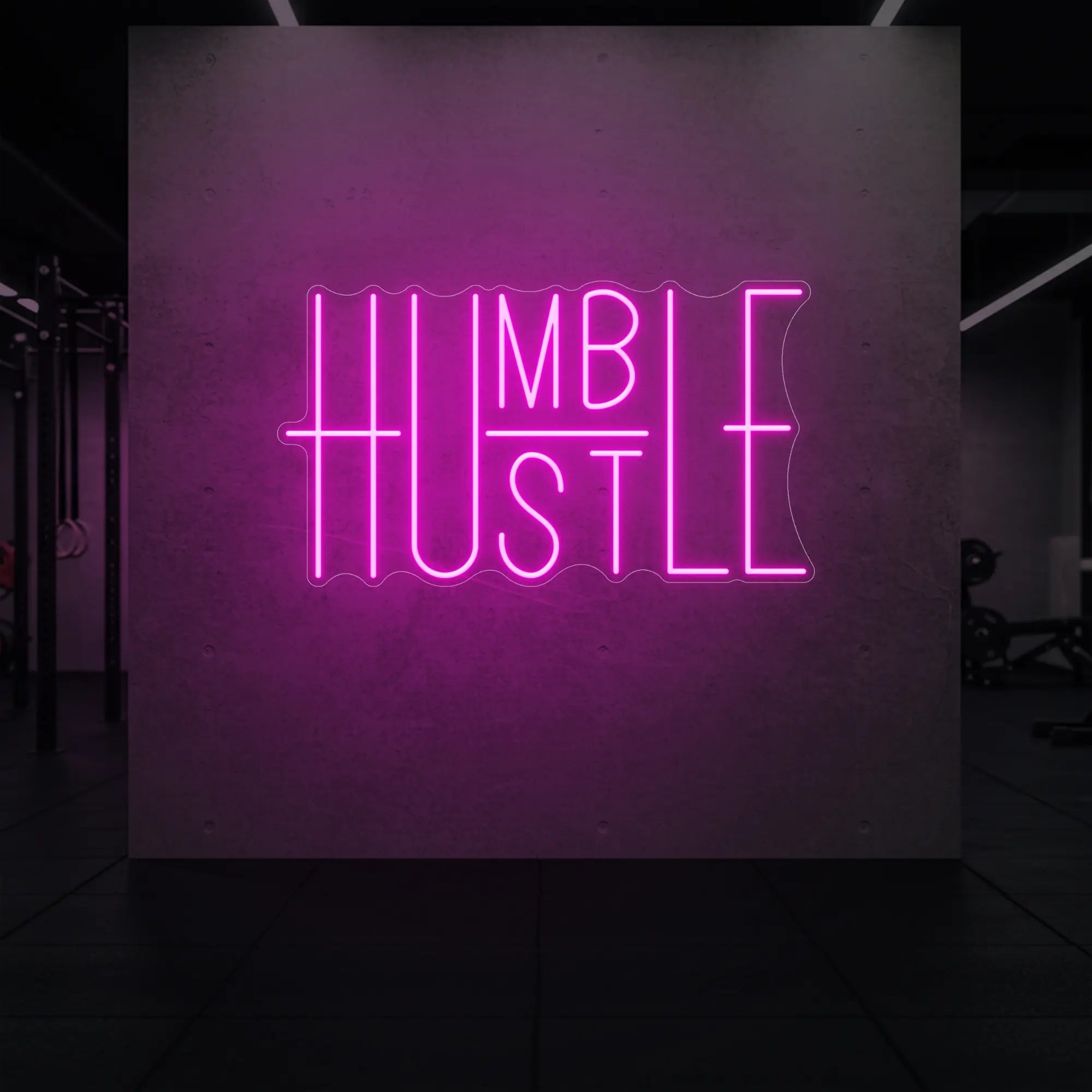 'Humble Hustle' neon sign glowing in light pink against a styled interior wall.