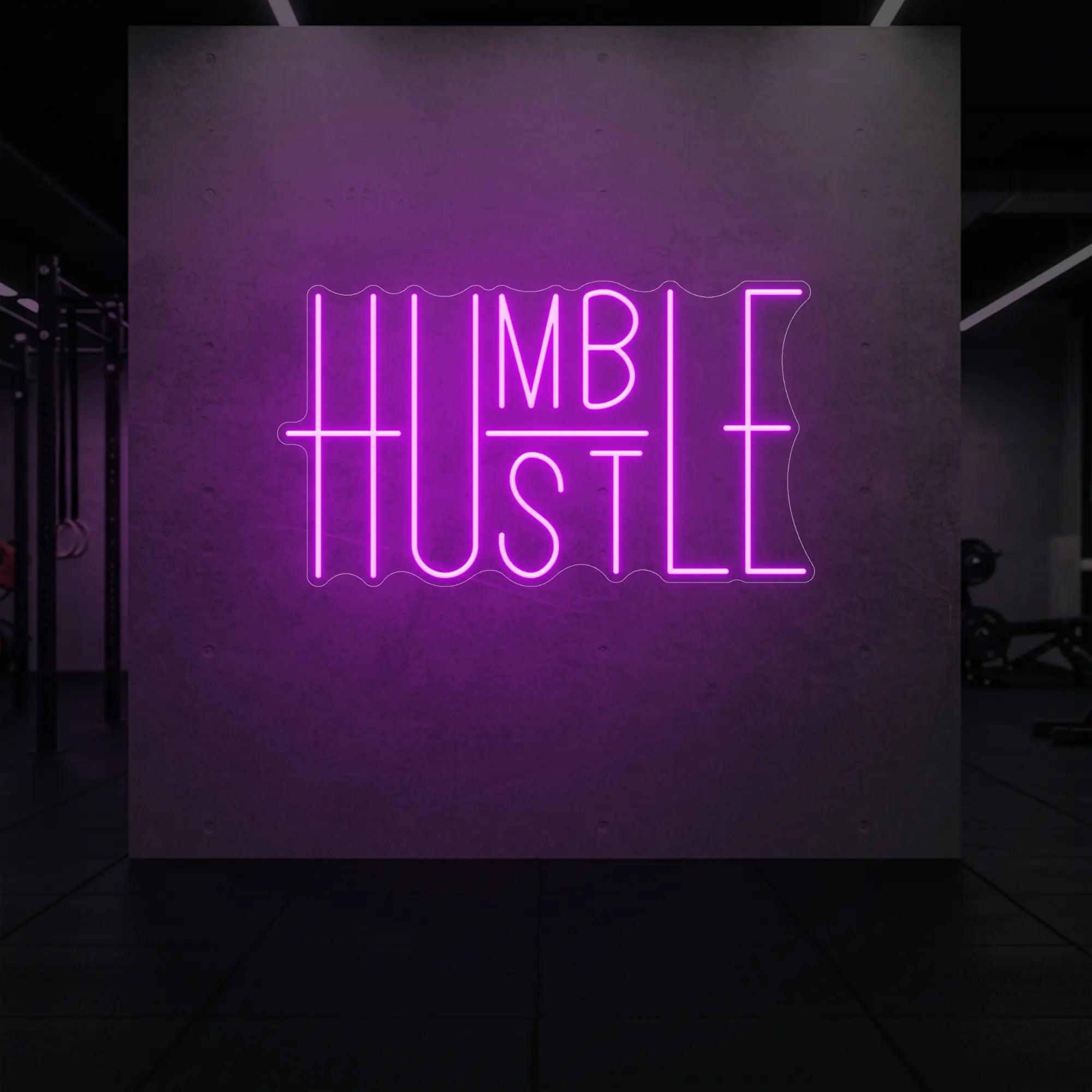  'Humble Hustle' neon sign glowing in deep pink against a styled interior wall.