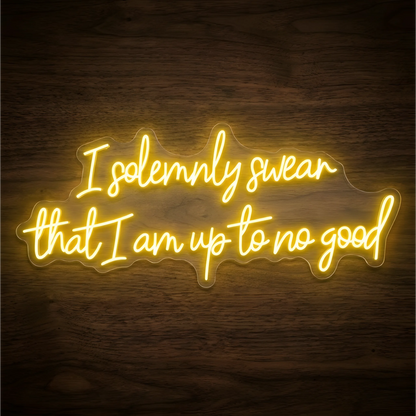 I Am Up to No Good LED Neon Sign displaying “I solemnly swear that I am up to no good” in glowing yellow script on clear acrylic against a dark wood background, suited to game rooms and home bars.