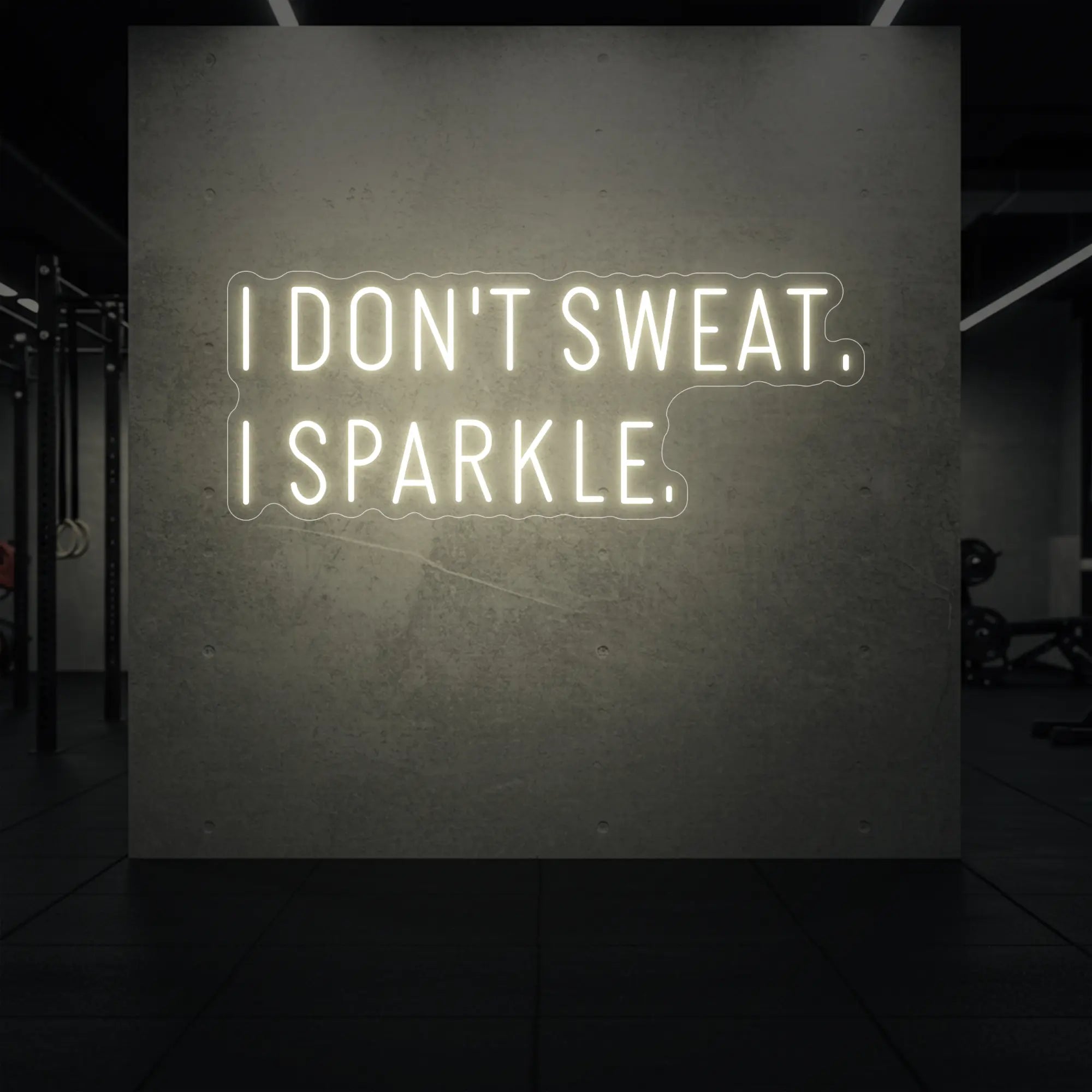  'I DON'T SWEAT. I SPARKLE.' neon sign glowing in warm white against a styled interior wall.