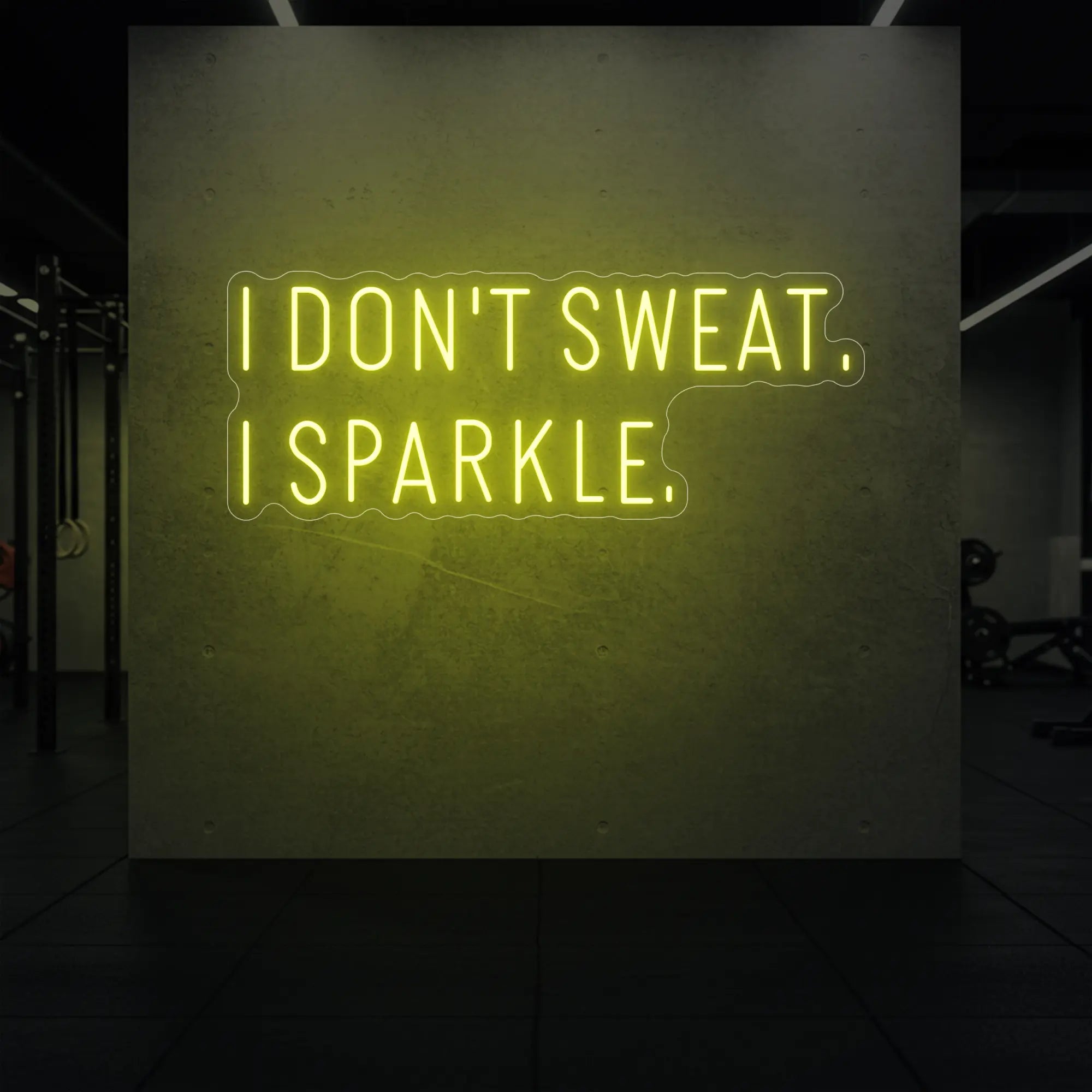 'I DON'T SWEAT. I SPARKLE.' neon sign glowing in lemon yellow against a styled interior wall.