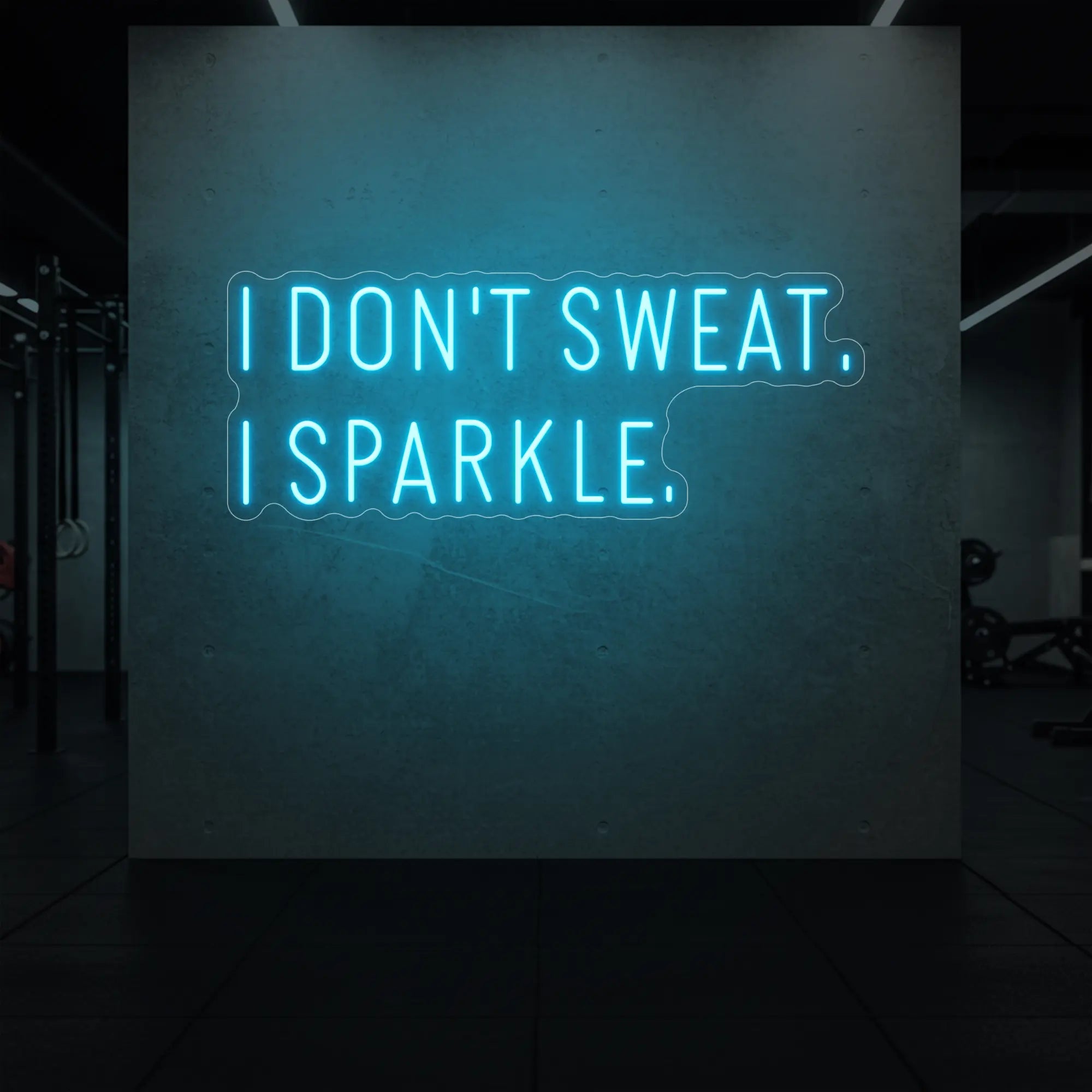  'I DON'T SWEAT. I SPARKLE.' neon sign glowing in ice blue against a styled interior wall.