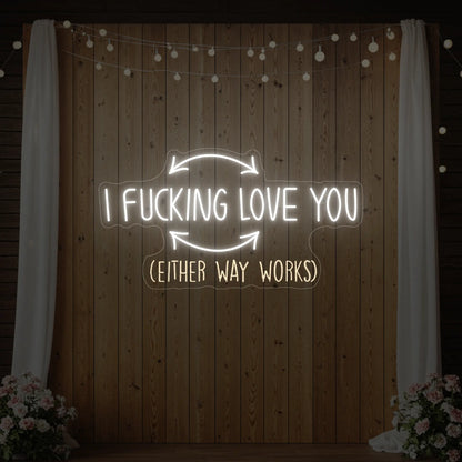 Photo of the 'I F'ing Love You' neon sign glowing in cool white against a styled interior wall.