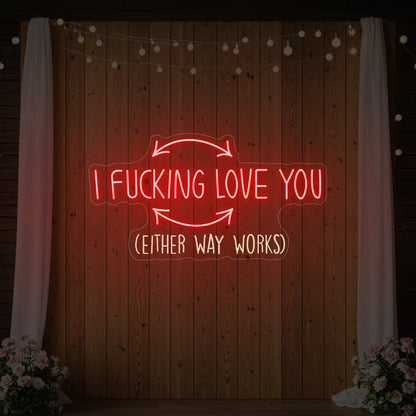 Photo of the 'I F'ing Love You' neon sign glowing in red against a styled interior wall.