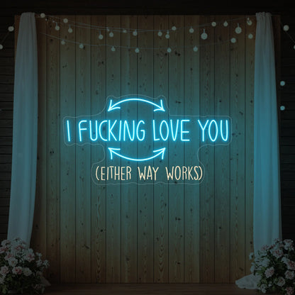 Photo of the 'I F'ing Love You' neon sign glowing in ice blue against a styled interior wall.