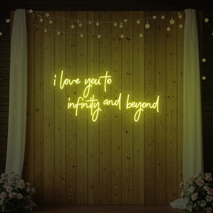Photo of the 'I Love You to Infinity and Beyond' neon sign glowing in lemon yellow against a styled interior wall.