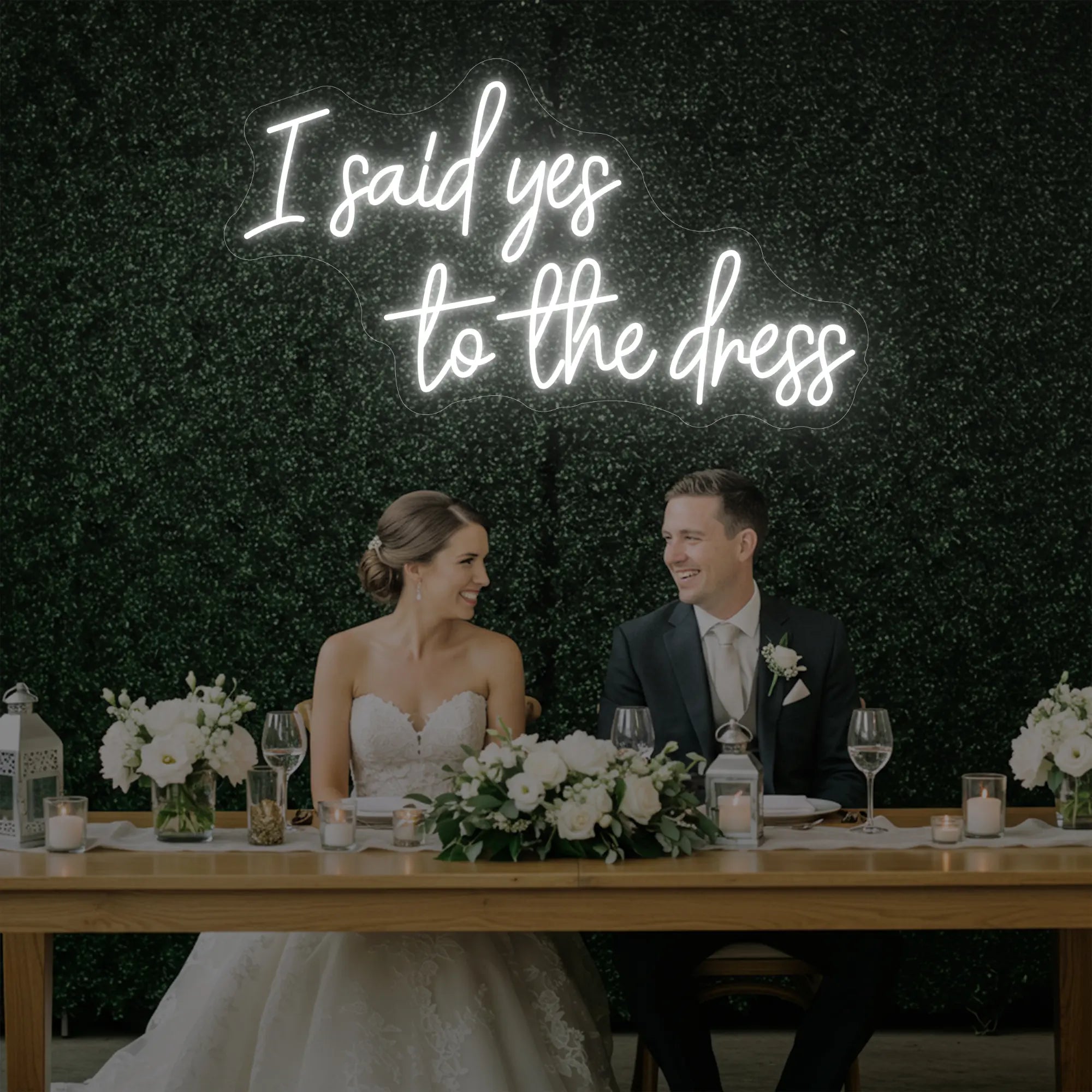 Photo of the 'I Said Yes To The Dress' neon sign glowing in cool white against a styled interior wall.