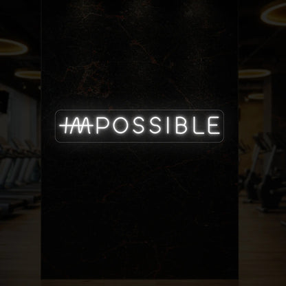 'IMPOSSIBLE' neon sign with the “IM” crossed out, glowing in cool white against a styled interior wall.