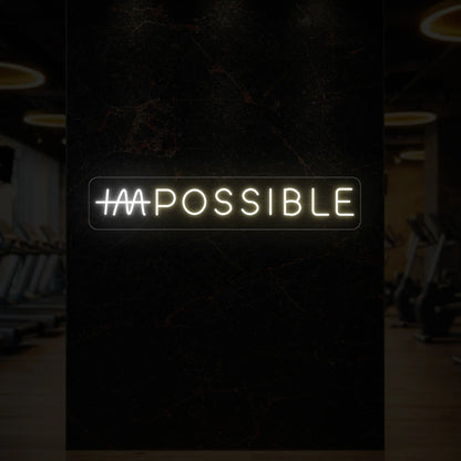  'IMPOSSIBLE' neon sign with the “IM” crossed out, glowing in warm white and cool white against a styled interior wall.