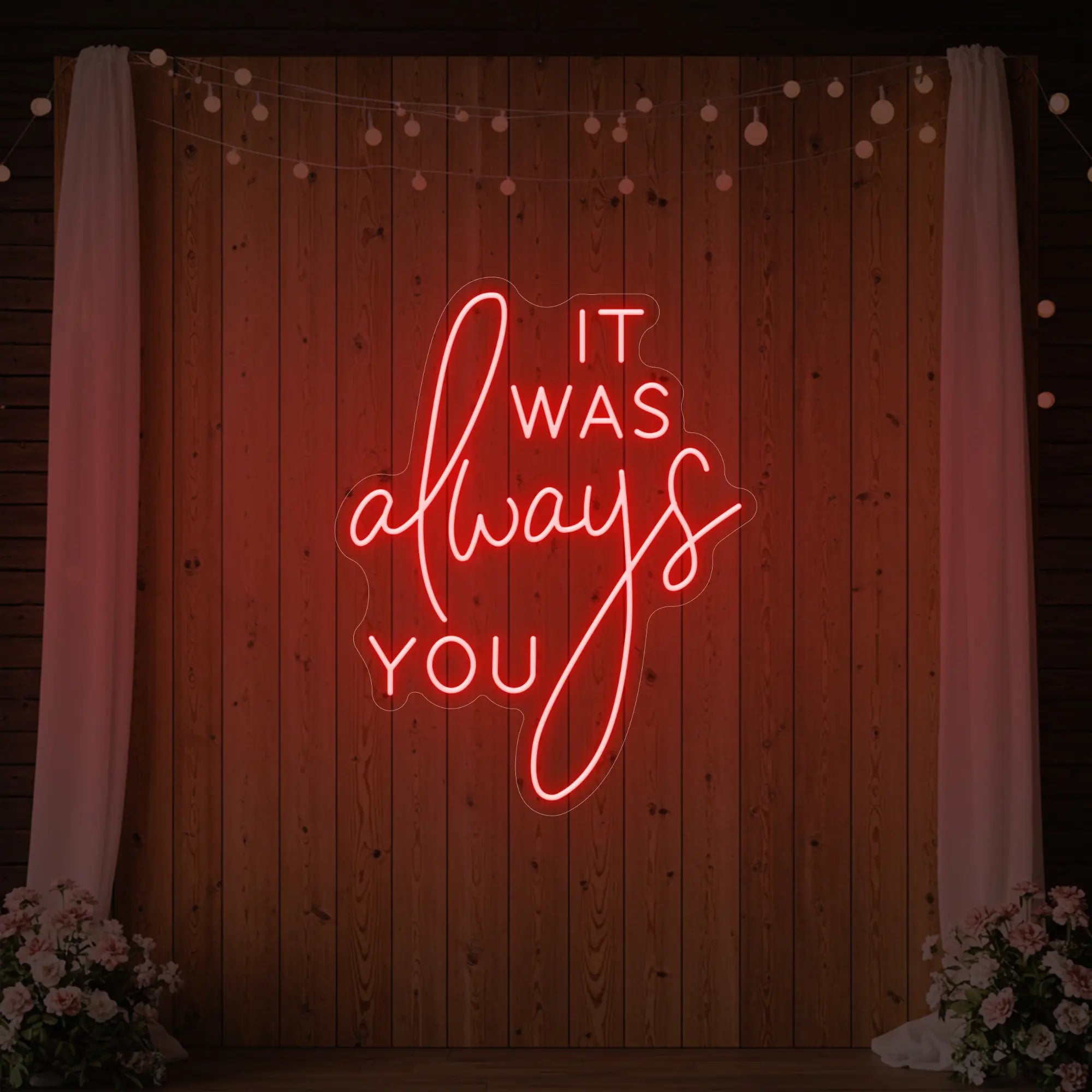 Photo of the 'It Was Always You' neon sign glowing in red against a styled interior wall.