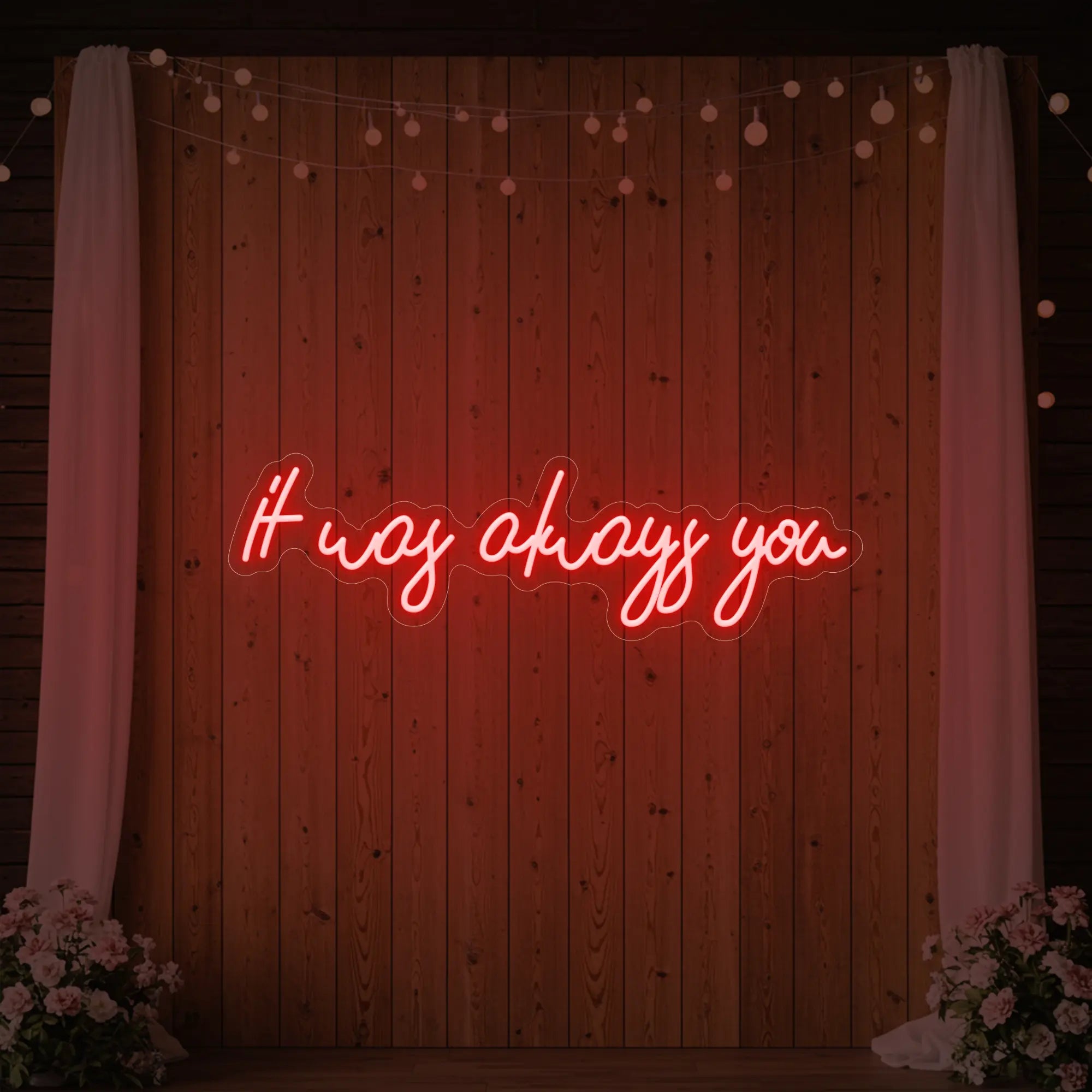 Photo of the 'It Was Always You' neon sign glowing in red against a styled interior wall.
