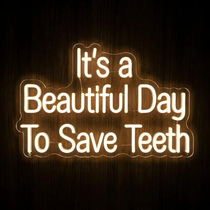 It's a Beautiful Day to Save Teeth LED neon sign featuring warm white illuminated quote lettering on clear acrylic backing for dental clinic, dentist office, and dental treatment room wall decor.
