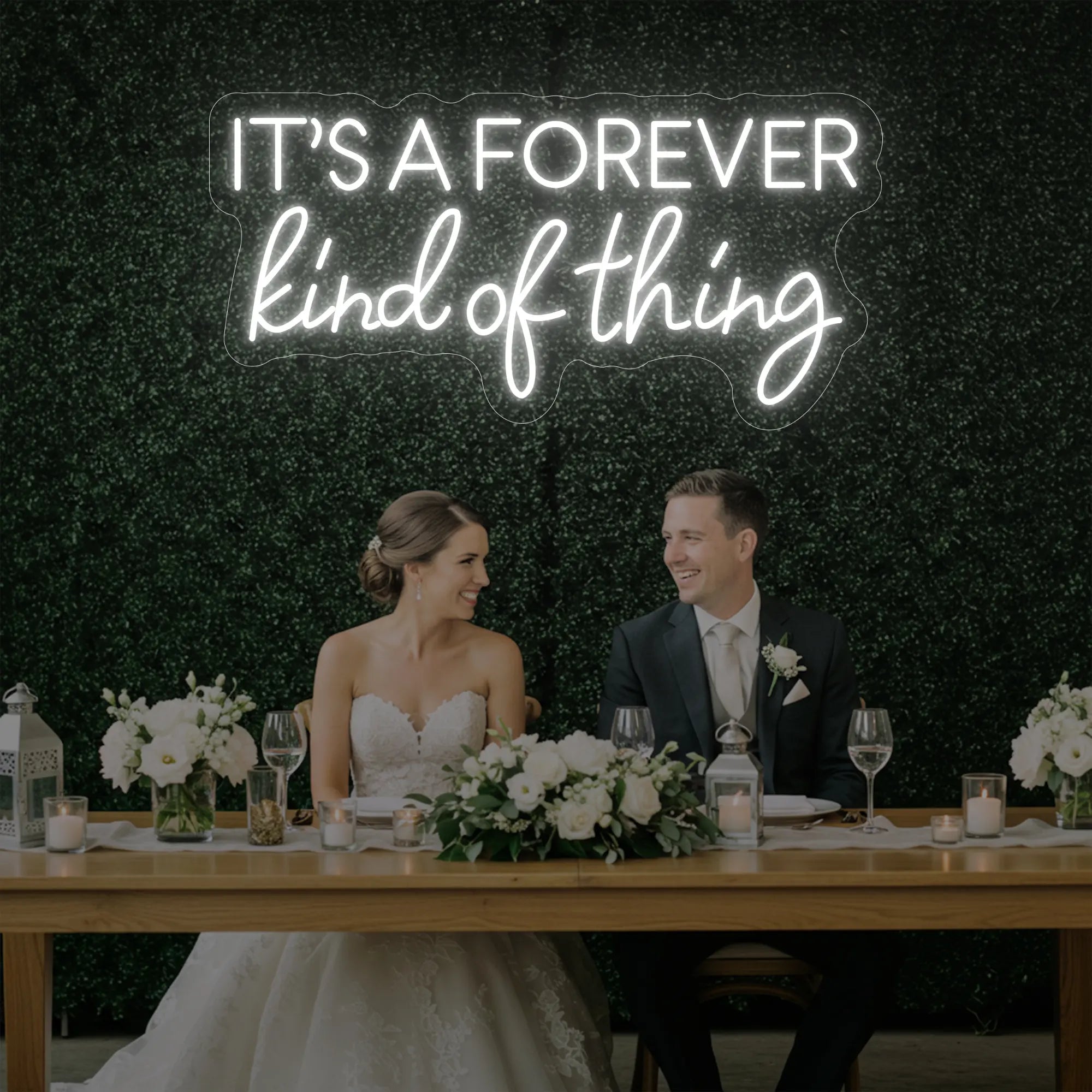 Photo of the 'It’s a Forever Kind of Thing' neon sign glowing in cool white against a styled interior wall.
