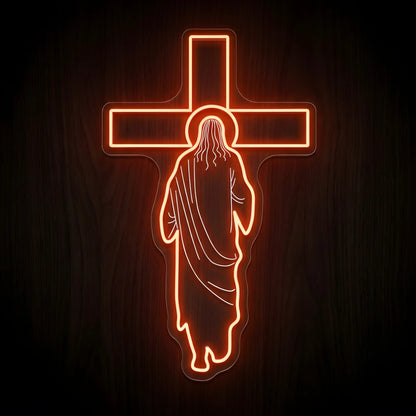 Jesus at the Cross LED neon sign featuring the silhouette of Jesus before a glowing cross with warm amber illumination on a precision-cut clear acrylic backing.