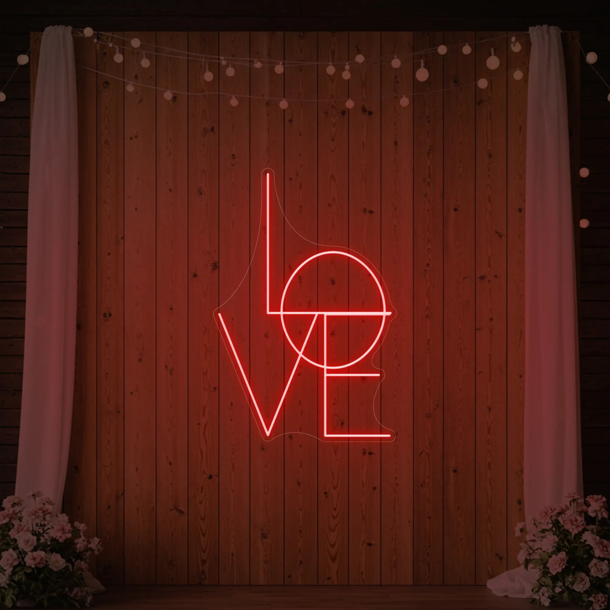 Photo of the 'LOVE' neon sign glowing in red against a styled interior wall.