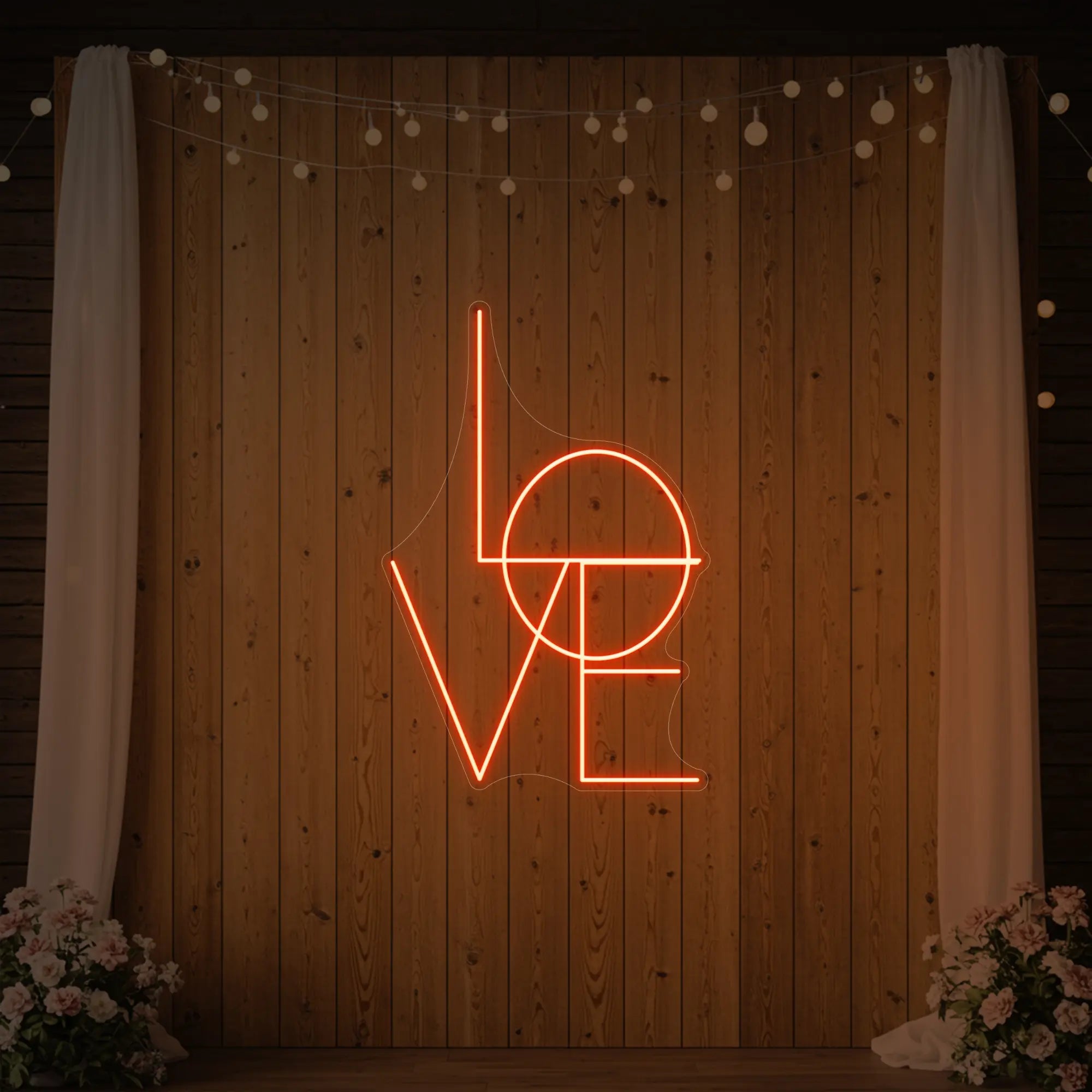 Photo of the 'LOVE' neon sign glowing in golden yellow against a styled interior wall.