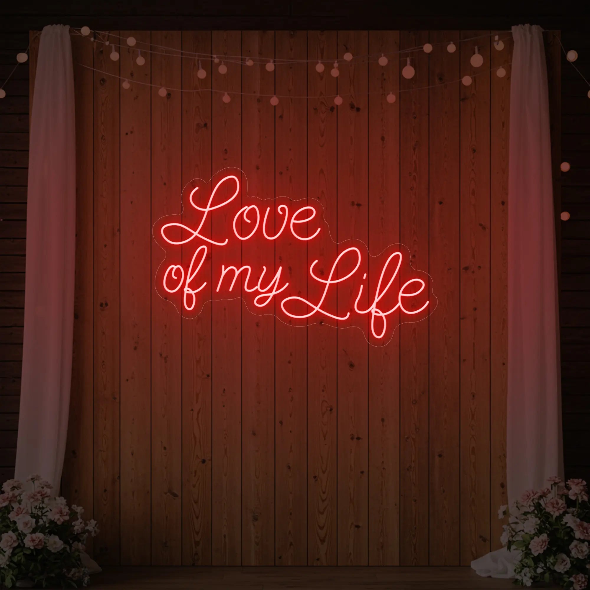 Photo of the 'Love of My Life' neon sign glowing in red against a styled interior wall.