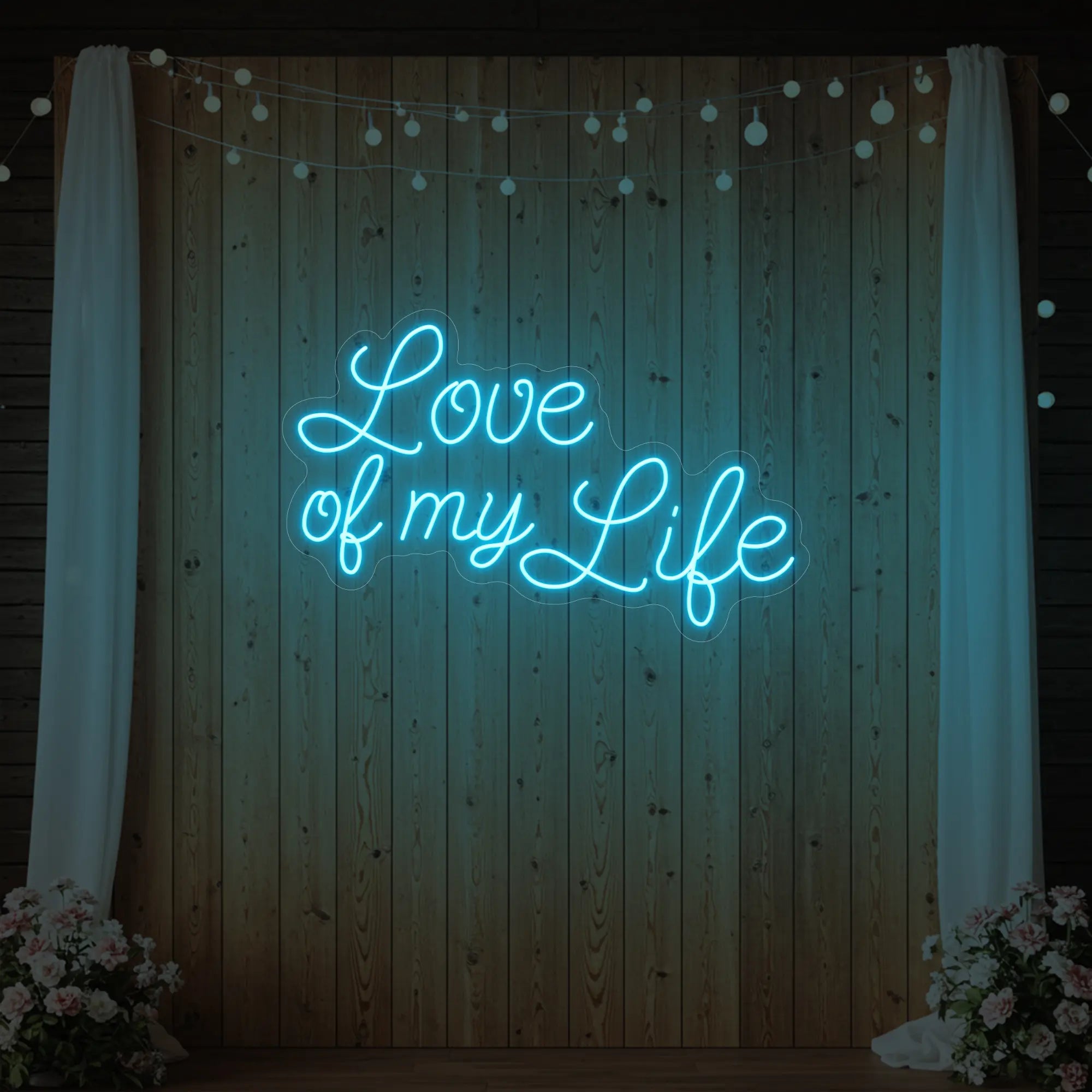 Photo of the 'Love of My Life' neon sign glowing in ice blue against a styled interior wall.