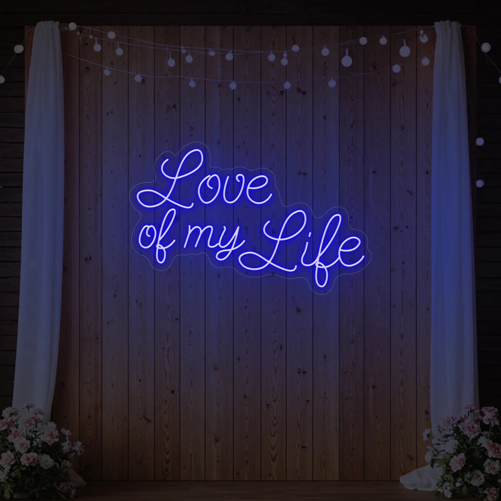 Photo of the 'Love of My Life' neon sign glowing in deep blue against a styled interior wall.