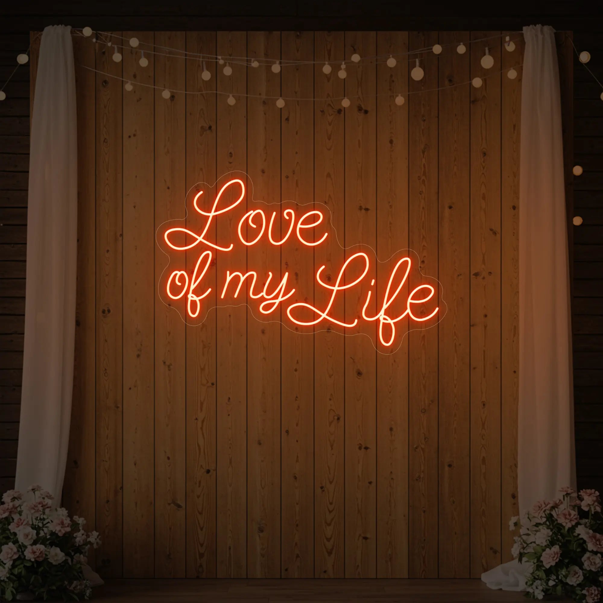 Photo of the 'Love of My Life' neon sign glowing in golden yellow against a styled interior wall.