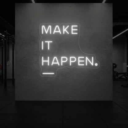 'MAKE IT HAPPEN' neon sign glowing in cool white against a styled interior wall.