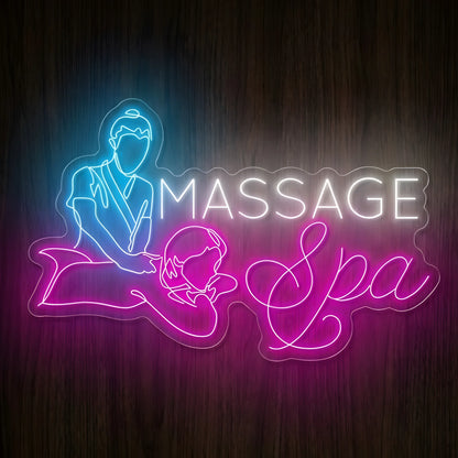 Massage Spa Treatment LED Neon Sign featuring blue massage therapist illustration, white MASSAGE lettering, and pink Spa script with a reclining client on clear acrylic against a dark wooden wall.