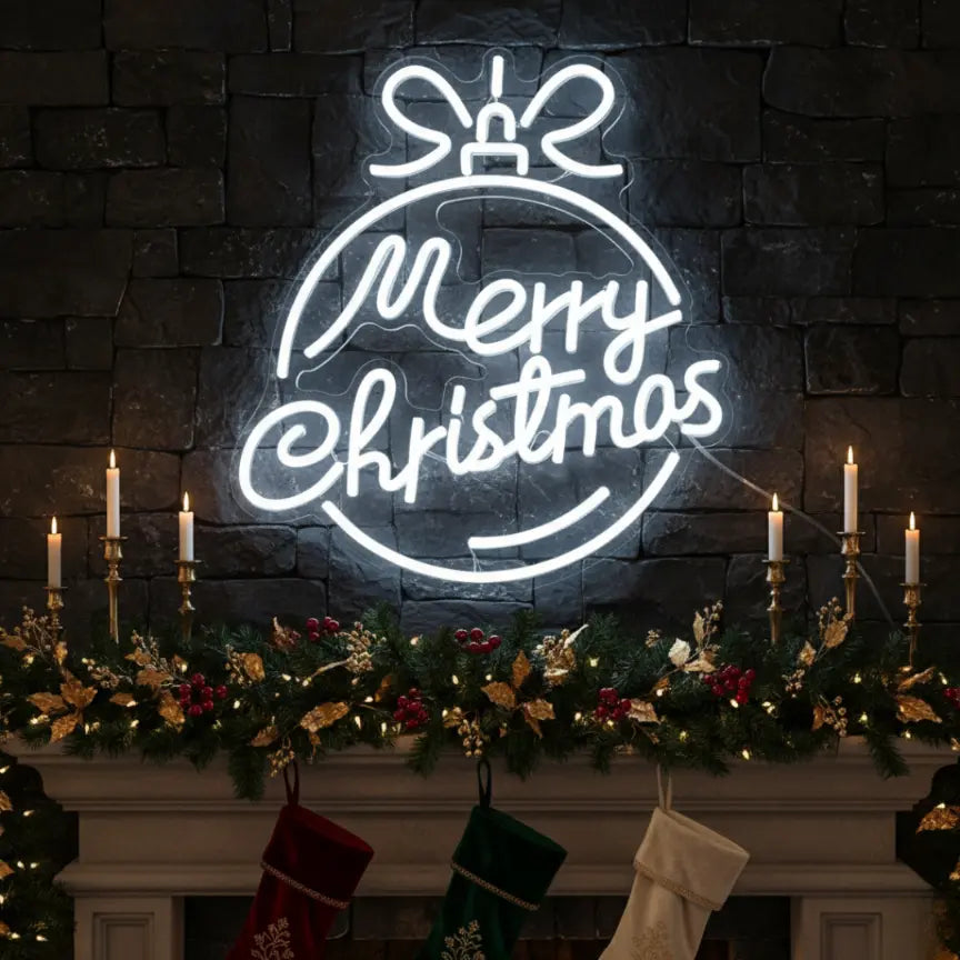 Photo of the 'Merry Christmas in a Christmas Ball' neon sign glowing in cool white against a styled interior wall.