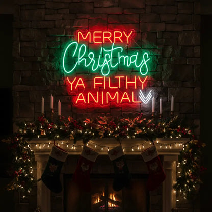 Photo of the 'Merry Christmas Ya Filthy Animal' neon sign glowing in multicolor against a styled interior wall.