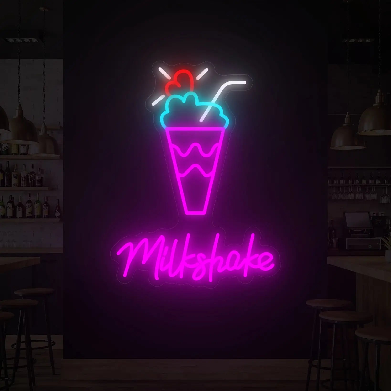 Photo of the 'MILKSHAKE' neon sign glowing in multi-color against a styled interior wall.