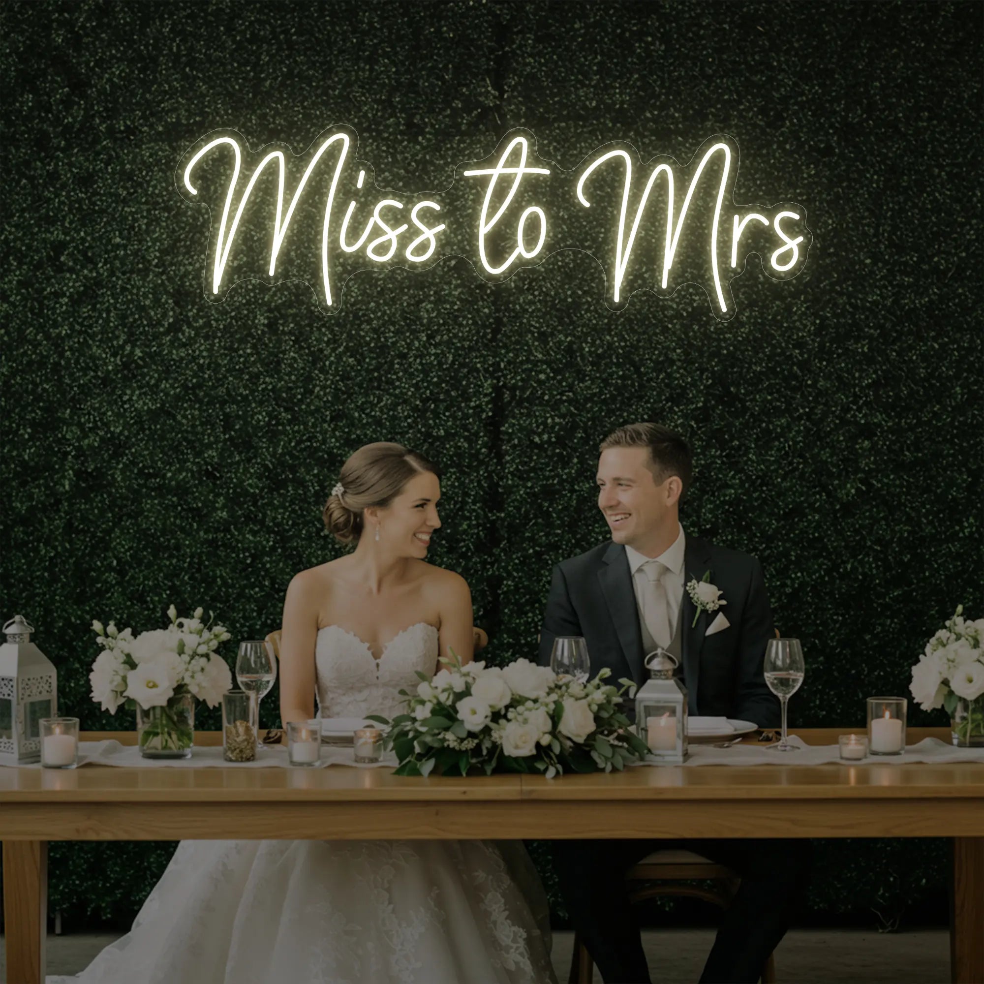 Photo of the 'Miss to Mrs' neon sign glowing in warm white against a styled interior wall.
