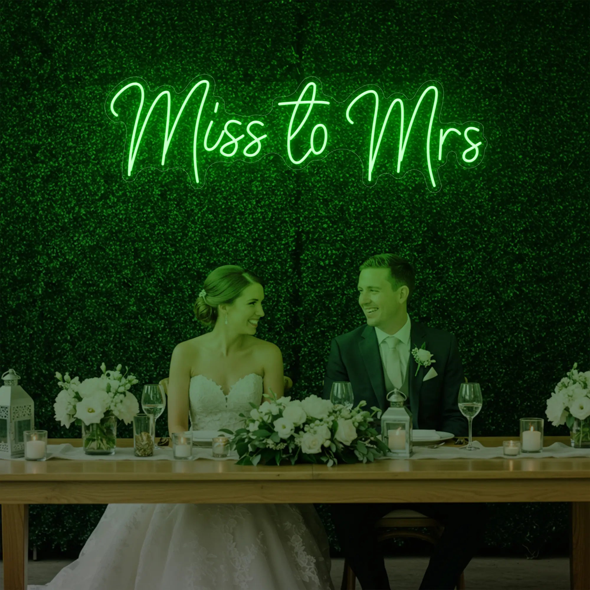 Photo of the 'Miss to Mrs' neon sign glowing in green against a styled interior wall.