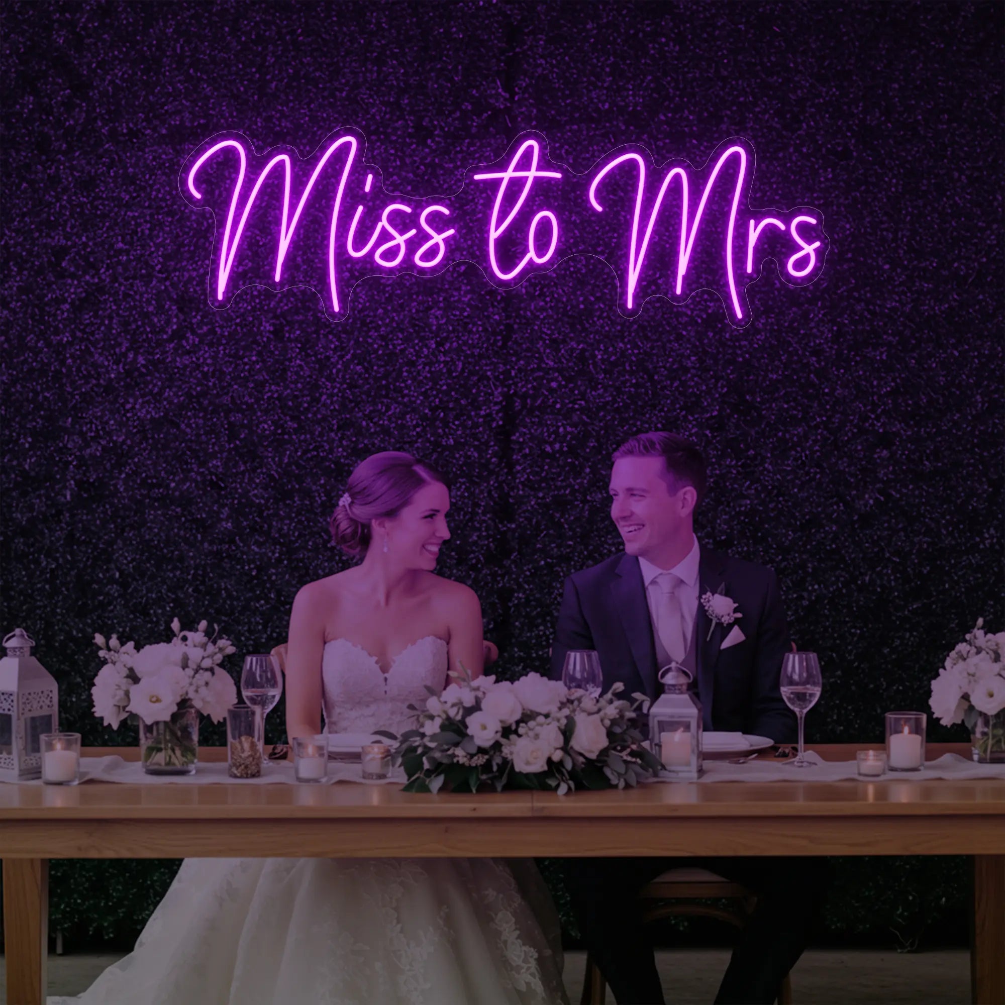 Photo of the 'Miss to Mrs' neon sign glowing in deep pink against a styled interior wall.