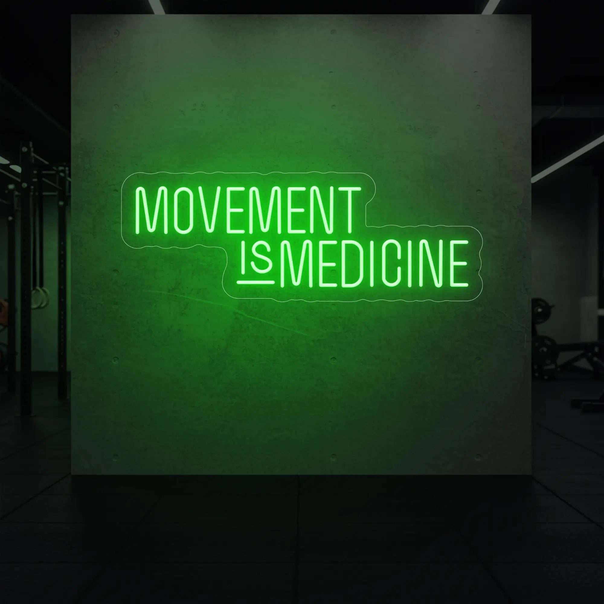  'Movement Is Medicine' neon sign glowing in green against a styled interior wall.