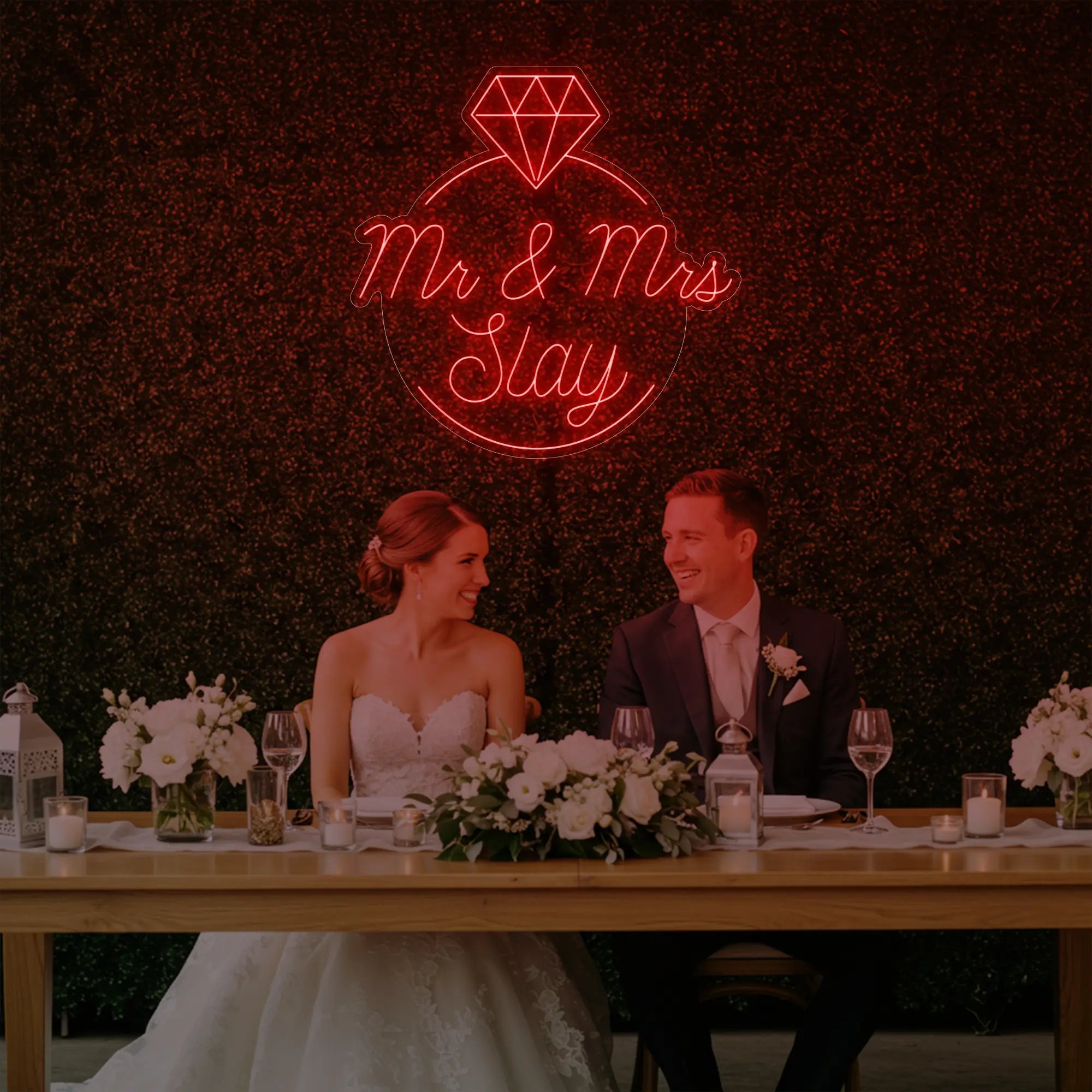 Photo of the 'Mr & Mrs EST' neon sign glowing in red against a styled interior wall.