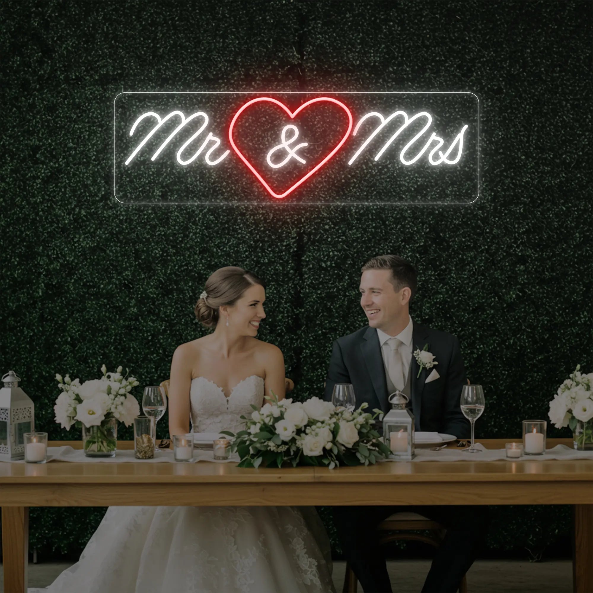 Photo of the 'Mr Heart Mrs' neon sign glowing in red and cool white against a styled interior wall.