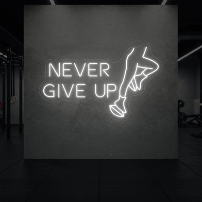 'NEVER GIVE UP' neon sign glowing in cool white against a styled interior wall.
