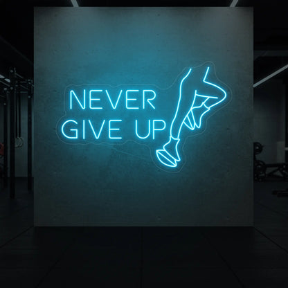  'NEVER GIVE UP' neon sign glowing in ice blue against a styled interior wall.