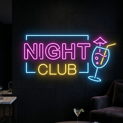 Photo of the 'Night Club' neon sign glowing in multi-color against a styled interior wall.
