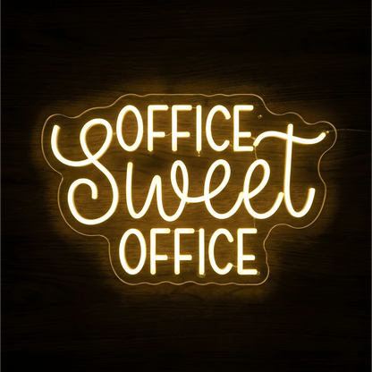 Office Sweet Office LED Neon Sign glowing warm yellow, with uppercase “OFFICE” lettering and script “Sweet” on clear acrylic against a dark wood background, suitable for home offices and workspaces.